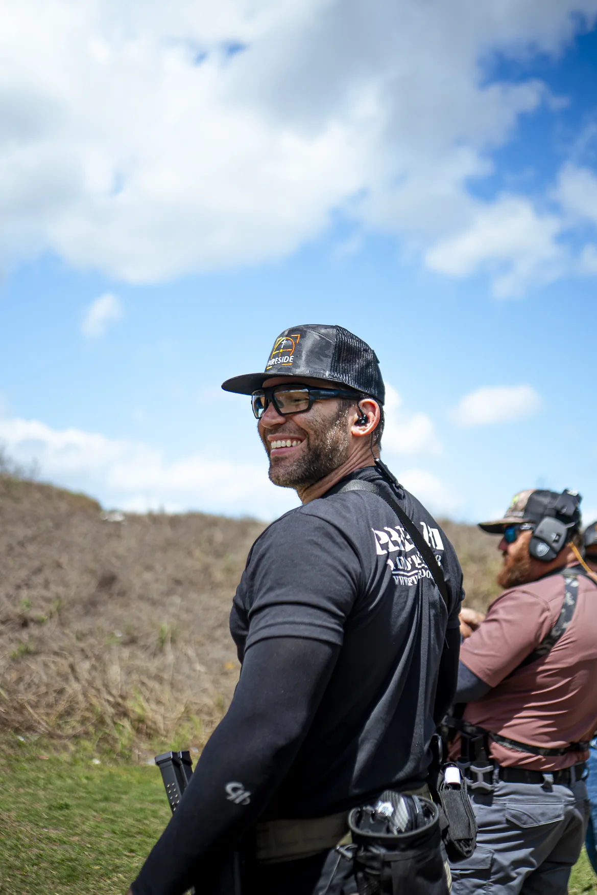 Keith Gibbs smiling in a Fireside hat against the sky